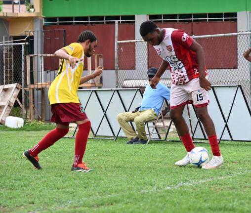 St. James High School’s Dondre Vernon (right) tries to shake the attentions of Muschett High’s Devantae Williams during their ISSA daCosta Cup preliminary round football game at Jarrett Park yesterday.